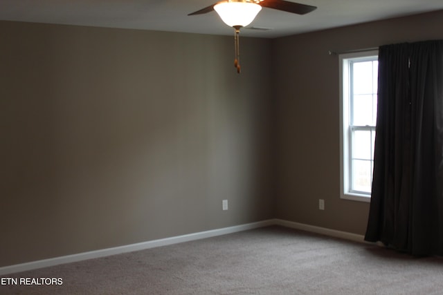 unfurnished room with a ceiling fan, a healthy amount of sunlight, and light carpet