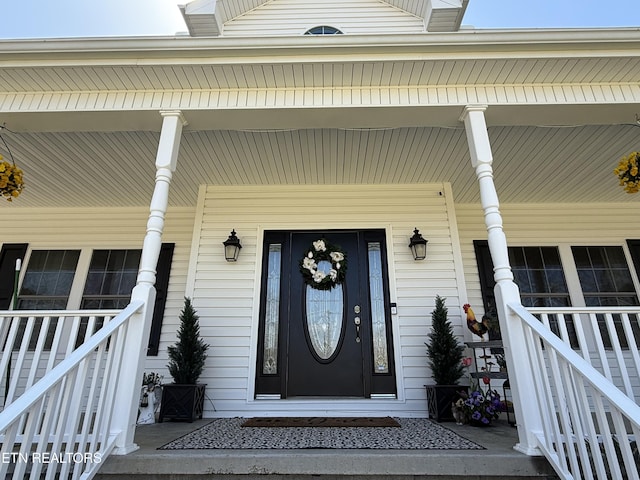 entrance to property featuring a porch