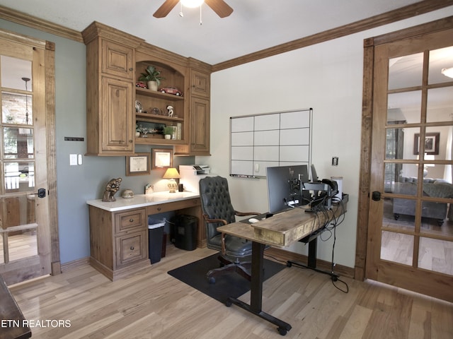 office area with baseboards, a ceiling fan, light wood-style floors, and ornamental molding