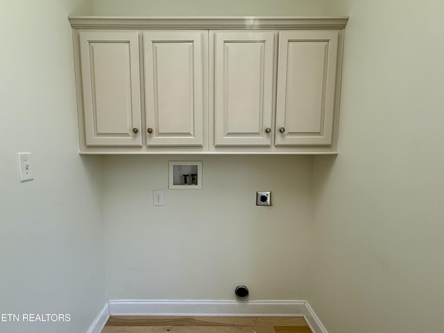 washroom with baseboards, hookup for a washing machine, wood finished floors, cabinet space, and electric dryer hookup