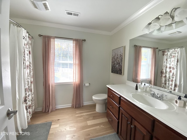 bathroom with visible vents, toilet, wood finished floors, crown molding, and vanity