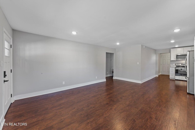 unfurnished living room featuring recessed lighting, dark wood-style floors, and baseboards