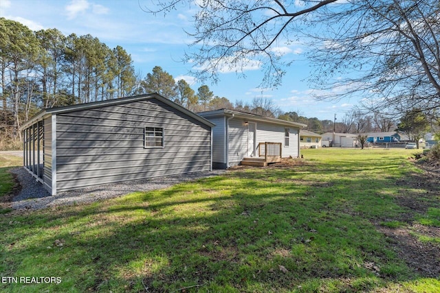 view of side of property with a lawn