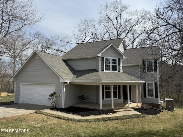 traditional-style home featuring a porch, concrete driveway, an attached garage, a shingled roof, and central AC unit