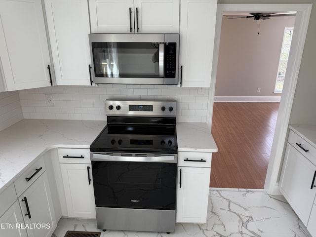 kitchen featuring white cabinetry, a ceiling fan, marble finish floor, and appliances with stainless steel finishes