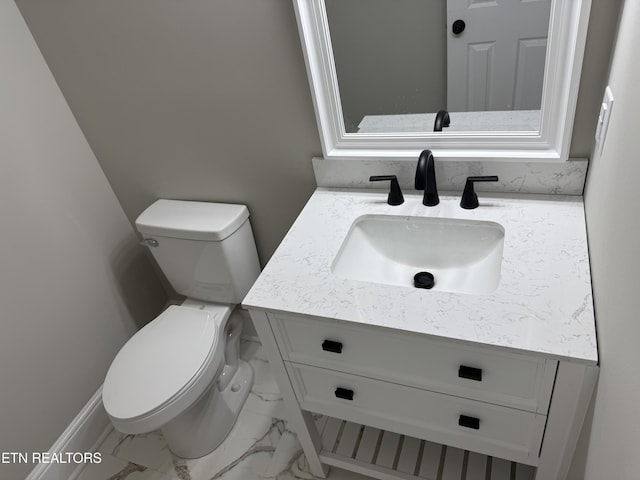 half bathroom with marble finish floor, toilet, and vanity