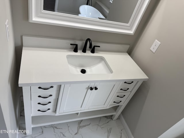 bathroom featuring marble finish floor and vanity