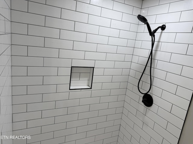 bathroom with tiled shower