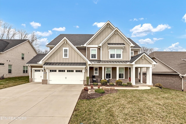 craftsman inspired home featuring a front yard, a standing seam roof, a porch, concrete driveway, and board and batten siding