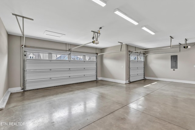 garage with electric panel, a garage door opener, and baseboards