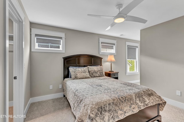 bedroom with carpet flooring, ceiling fan, visible vents, and baseboards