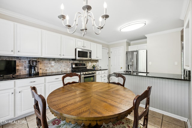 5633 Eagle Crest Ln, Knoxville, TN 37921 - dining space featuring crown molding, light tile patterned floors, and a chandelier