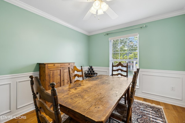 5633 Eagle Crest Ln, Knoxville, TN 37921 - dining area with crown molding, a ceiling fan, wainscoting, and wood finished floors