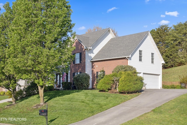 5633 Eagle Crest Ln, Knoxville, TN 37921 - view of front of property with a front yard, a shingled roof, a garage, brick siding, and driveway
