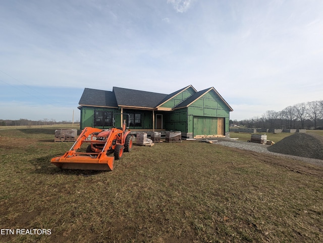 exterior space with a front lawn, an attached garage, and driveway