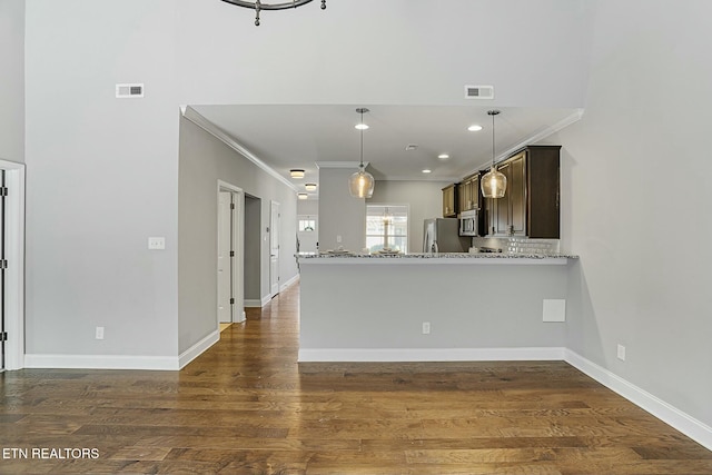 kitchen featuring visible vents, light stone countertops, stainless steel appliances, and dark wood-style flooring