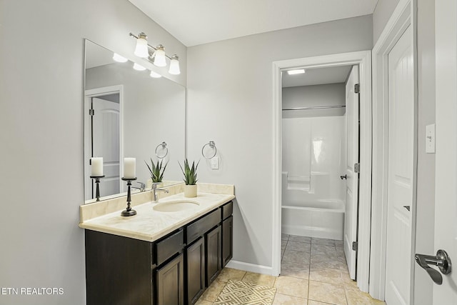 full bathroom featuring tile patterned floors, tub / shower combination, vanity, and baseboards