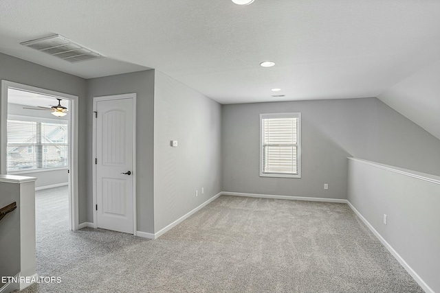 bonus room featuring a wealth of natural light, visible vents, and carpet