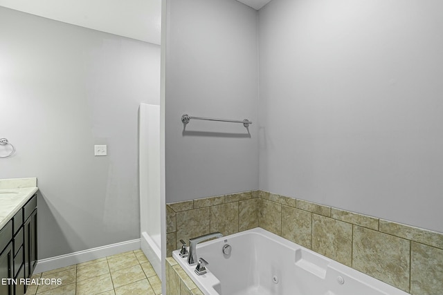 full bathroom with vanity, tile patterned floors, a jetted tub, and baseboards