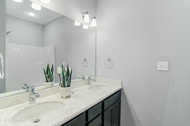 bathroom featuring double vanity and a sink