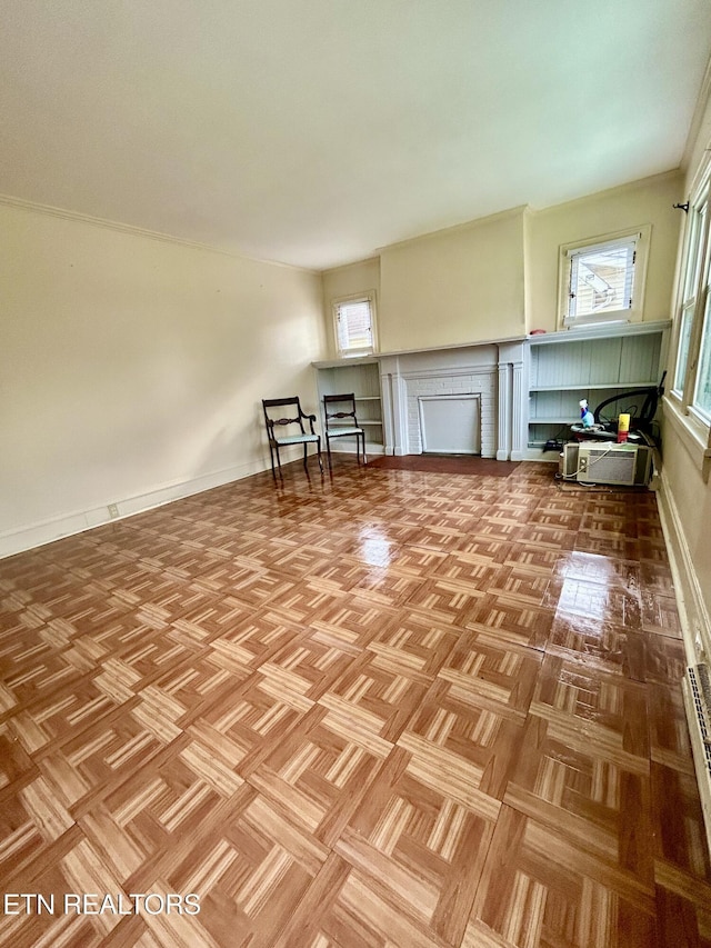 interior space featuring baseboards, a brick fireplace, and a healthy amount of sunlight