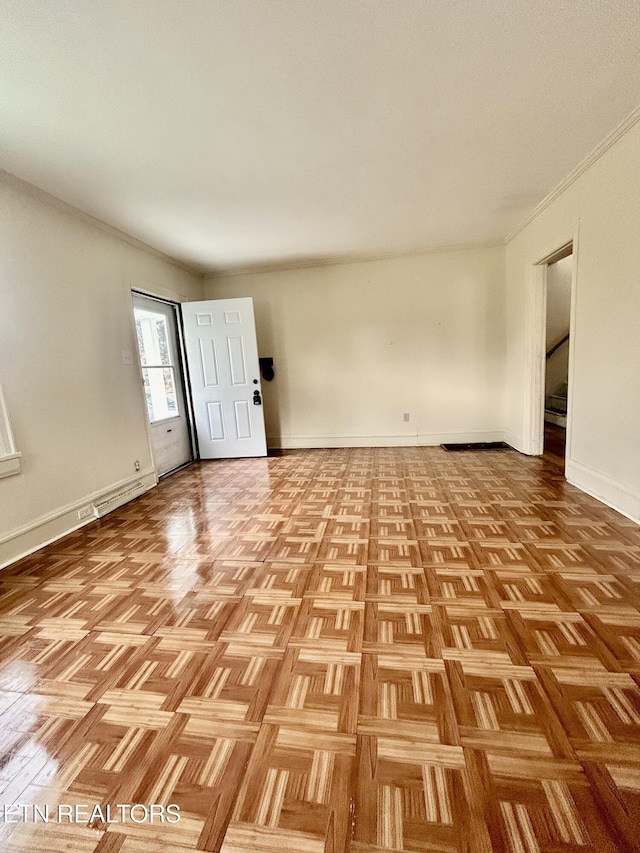 empty room featuring baseboards and stairs