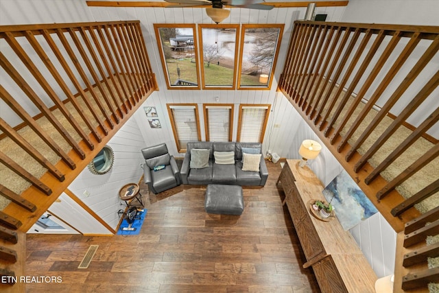 2092 Lakewood Dr, Loudon, TN 37774 - living room featuring wood finished floors, stairway, wooden walls, and ceiling fan