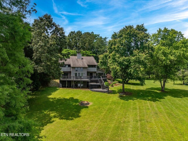 2092 Lakewood Dr, Loudon, TN 37774 - view of green lawn featuring a deck, stairs, and a fire pit