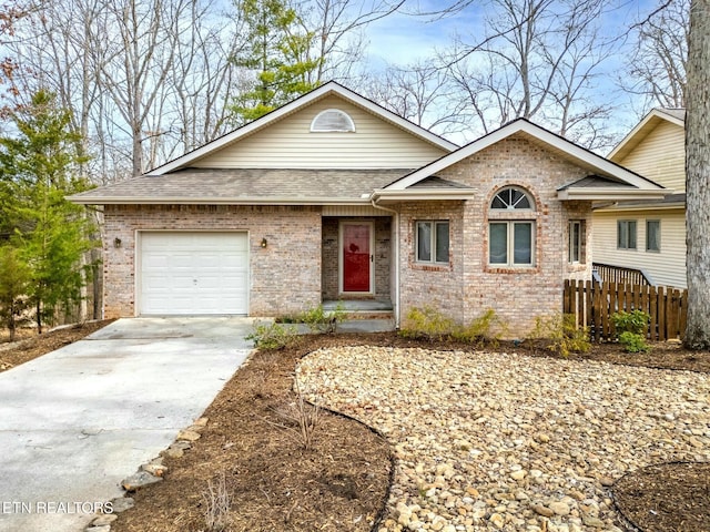 single story home featuring brick siding, driveway, a shingled roof, and fence