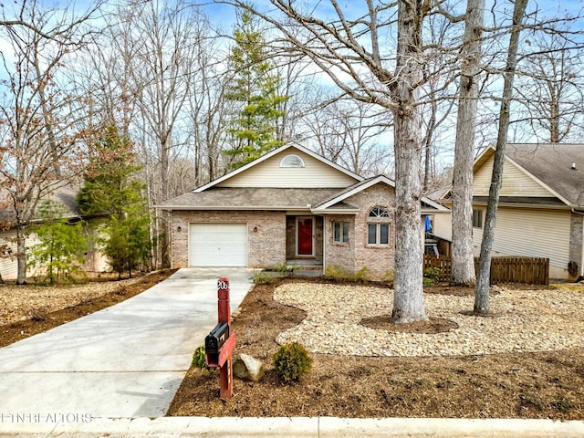 ranch-style home featuring concrete driveway, an attached garage, brick siding, and roof with shingles