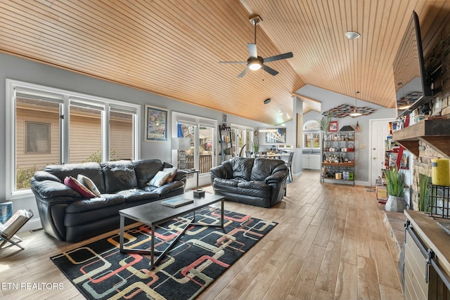 living room with vaulted ceiling, plenty of natural light, wood finished floors, and ceiling fan