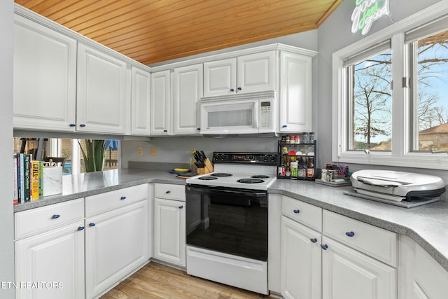 kitchen with electric range, light wood-style floors, white cabinets, white microwave, and wood ceiling