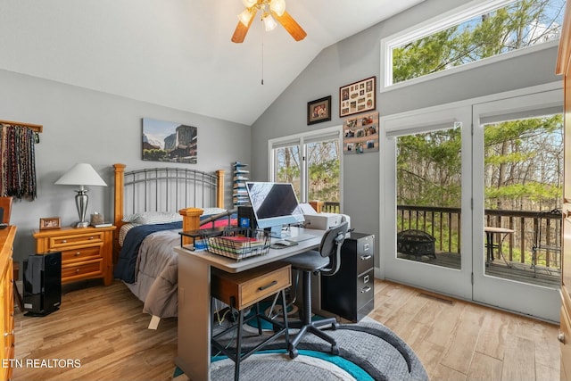 bedroom featuring light wood-style flooring, multiple windows, high vaulted ceiling, and access to exterior