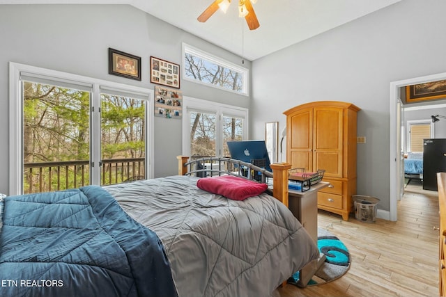 bedroom with baseboards, high vaulted ceiling, light wood-style flooring, ceiling fan, and access to exterior