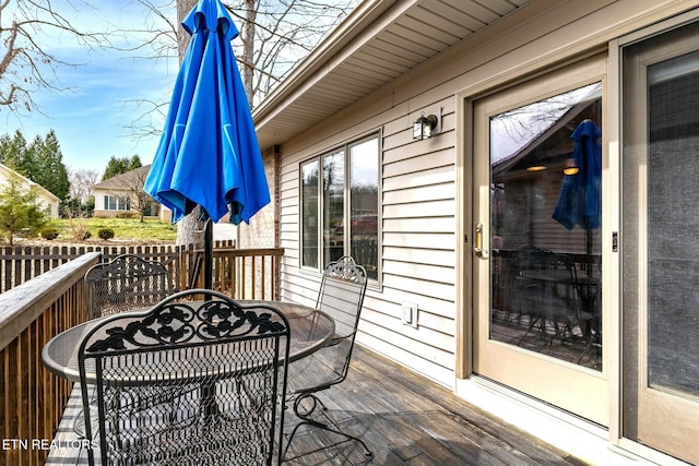 wooden terrace with outdoor dining area