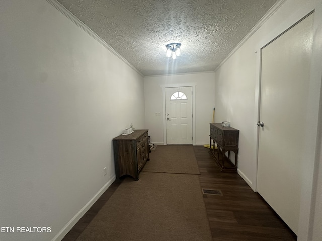 doorway to outside featuring visible vents, baseboards, ornamental molding, wood finished floors, and a textured ceiling