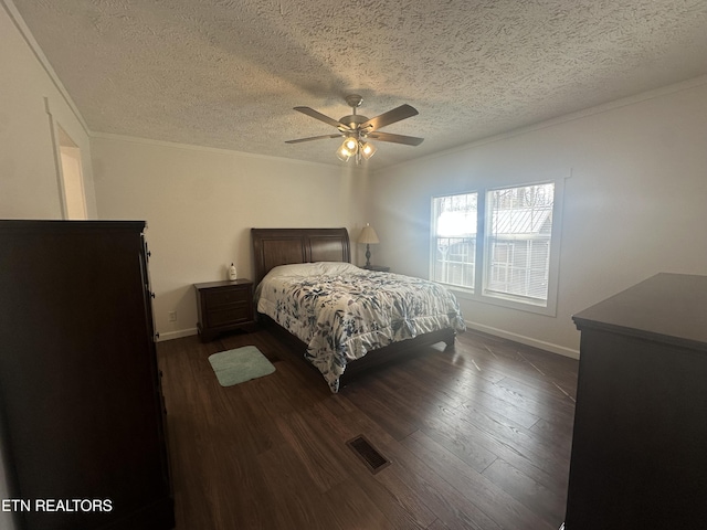 bedroom featuring dark wood finished floors, visible vents, baseboards, and a ceiling fan