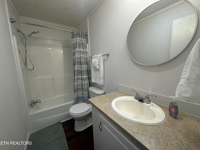 full bathroom featuring vanity, wood finished floors, a textured ceiling, toilet, and shower / tub combo with curtain