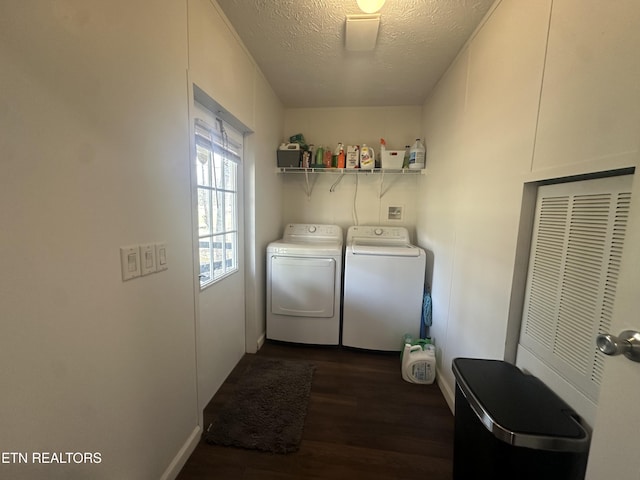 laundry room featuring washing machine and clothes dryer, laundry area, dark wood finished floors, and a textured ceiling