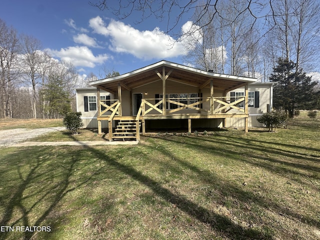 view of front of house with a deck and a front lawn