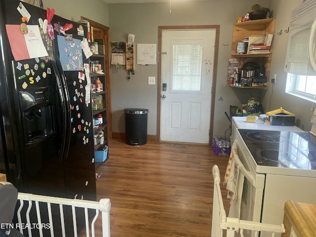 kitchen with white appliances and wood finished floors