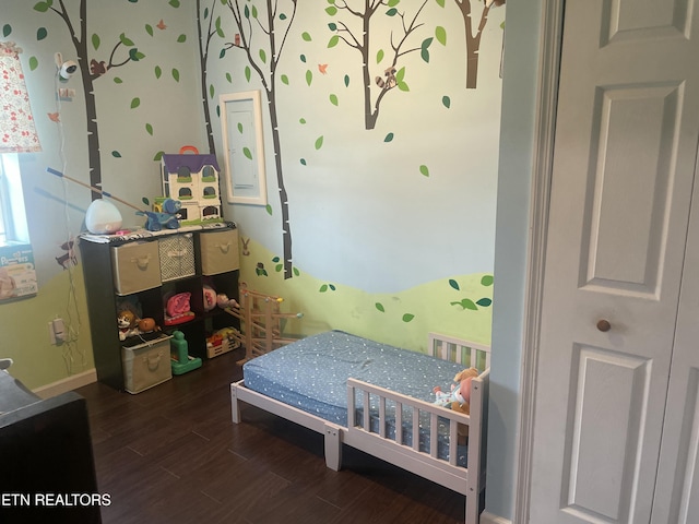 bedroom featuring baseboards and wood finished floors