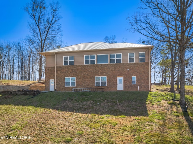 285 Redwood Dr, Dandridge, TN 37725 - view of side of property featuring a yard, brick siding, and a metal roof