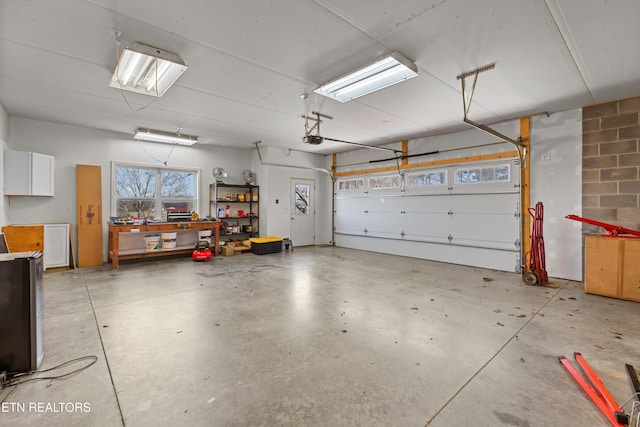 285 Redwood Dr, Dandridge, TN 37725 - garage featuring a garage door opener and a workshop area