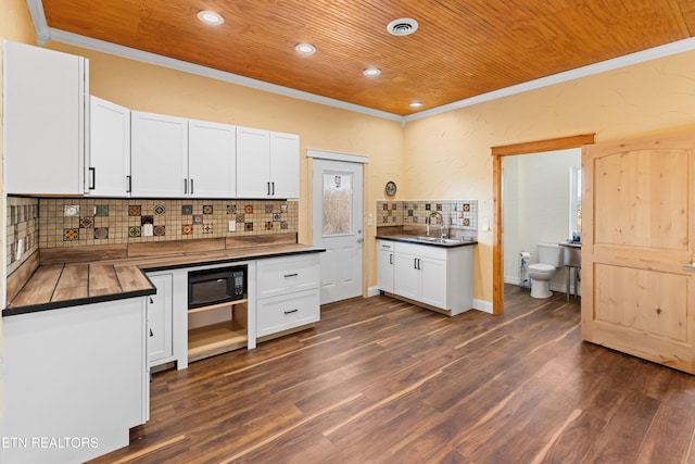 285 Redwood Dr, Dandridge, TN 37725 - kitchen featuring wooden ceiling, crown molding, black microwave, tasteful backsplash, and white cabinetry