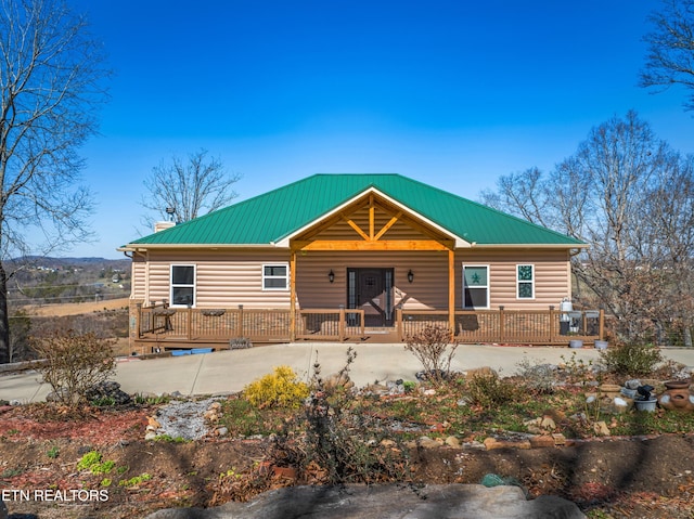 285 Redwood Dr, Dandridge, TN 37725 - view of front of property with a chimney, a metal roof, faux log siding, and covered porch