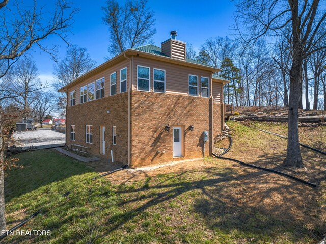 285 Redwood Dr, Dandridge, TN 37725 - rear view of property with a chimney, a lawn, and brick siding
