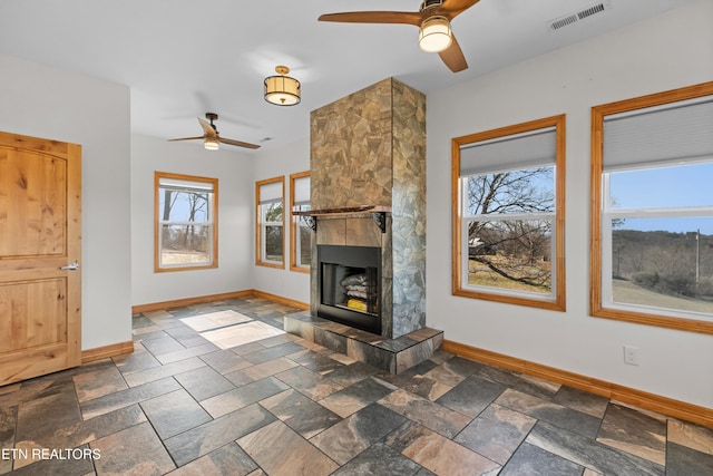 285 Redwood Dr, Dandridge, TN 37725 - unfurnished living room featuring ceiling fan, a fireplace, and dark stone finish flooring