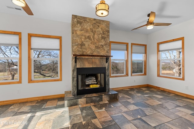 285 Redwood Dr, Dandridge, TN 37725 - unfurnished living room featuring ceiling fan, plenty of natural light, and stone tile flooring