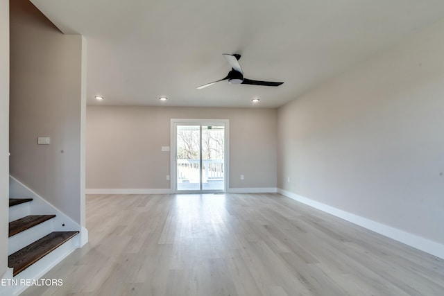 unfurnished living room with baseboards, light wood-type flooring, and ceiling fan